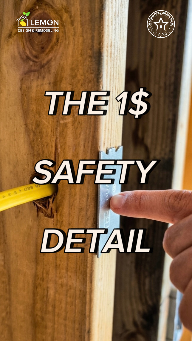 A heavy-duty metal strike plate installed on a wooden framing stud to protect electrical wiring and plumbing lines during a home remodeling rough-in phase.